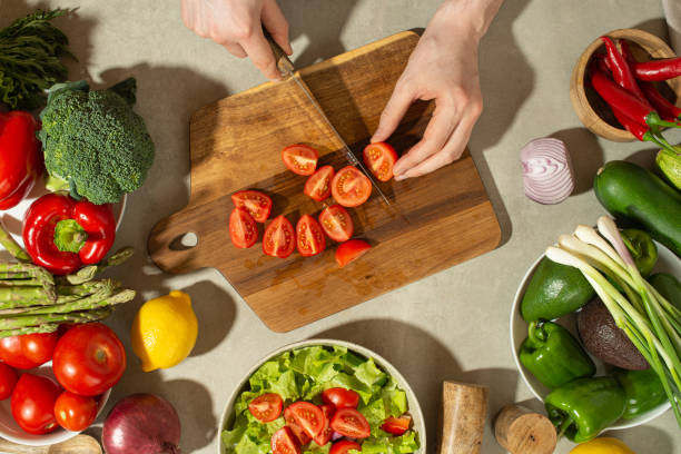 istock A man prepares a vegetable salad with a whole apron, close-up 1501789645