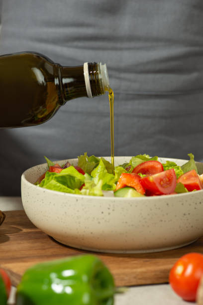 istock A man prepares a vegetable salad with a whole apron, close-up 1501790318