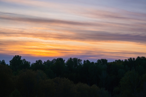 The sky displays a beautiful orange hue during sunrise or sunset.