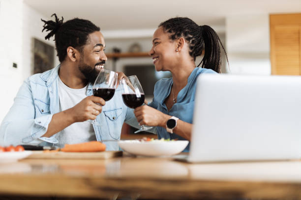 istock Happy black couple toasting with wine in dining room 1501793061