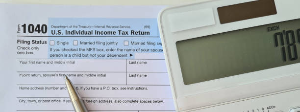 istock Tax forms pen and checks with calculator 1501794090