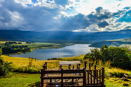 solar flare and sun rays over Maloti Drakensberg mountains and bell park dam in KZN