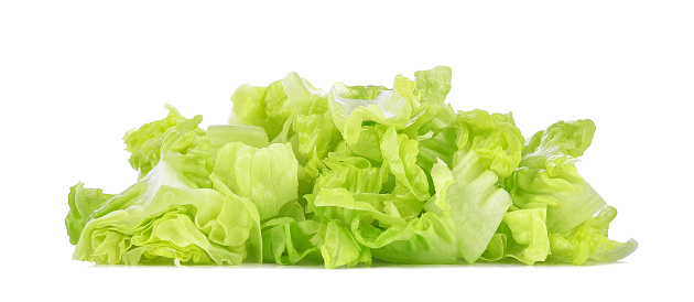 Chopped green lettuce isolated on white background