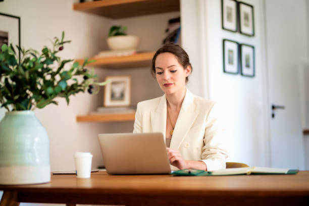 istock Young businesswoman using laptop and working from home 1501797844