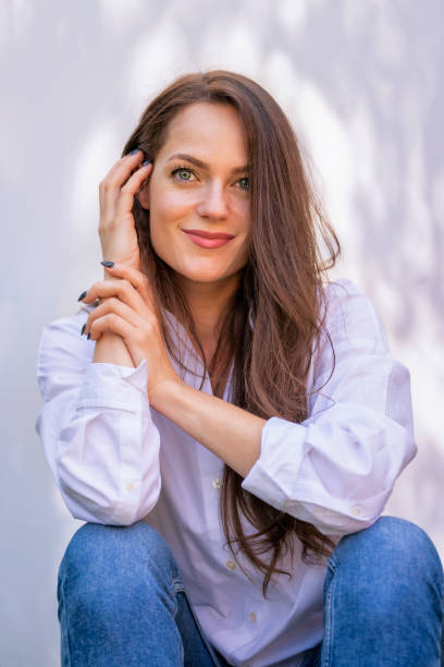 istock Beautiful woman sitting in the sunlight and smiling 1501798288