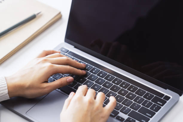 istock Against a blurred office background, the image captures a woman's hands typing on a sleek laptop keyboard 1501805112