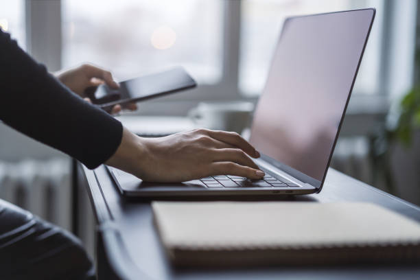 Woman's fingers nimbly typing on a cutting-edge laptop keyboard, with a blurred office scene behind Woman's fingers nimbly typing on a cutting-edge laptop keyboard, with a blurred office scene behind nimbly stock pictures, royalty-free photos & images