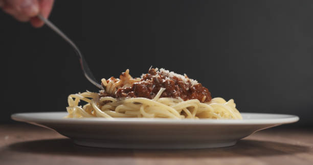 istock eating spaghetti with bolognese sauce with fork 1501821661