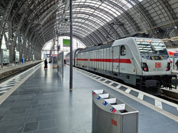 Frankfurt (Main) Hauptbahnhof (Frankfurt Central Station), is the busiest railway station in the German state of Hesse. The image shows an old locomotive and a Railroad Station Platform.