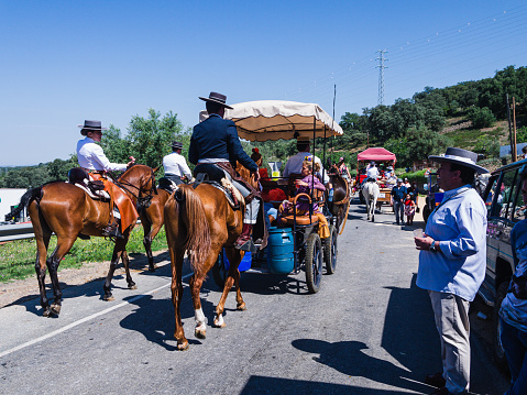 Huelva,Spain - June 16, 2023, man on horseback with a Cordovan hat, walking behind the sinless of his brotherhood on the way to the pilgrimage of El Rocio.