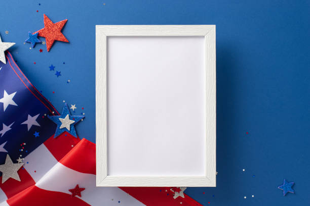 istock National Labour Day concept. Top view photo of empty rectangular wooden frame with american flag and white, red and blue star-shaped sparkles on blue isolated background with copy-space 1501859403