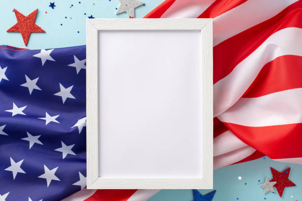 istock The fourth of july celebration concept. Above view photo empty rectangular frame surrounded by red, white and blue confetti stars and american flag on blue isolated background with copy-space 1501859438