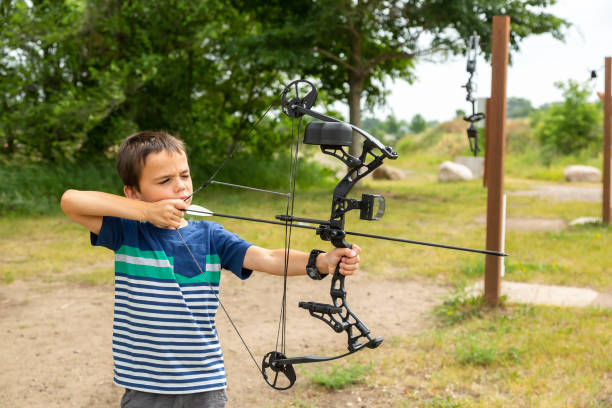istock Young Boy Practicing Archery at Outdoor Range in Summer 1501880855