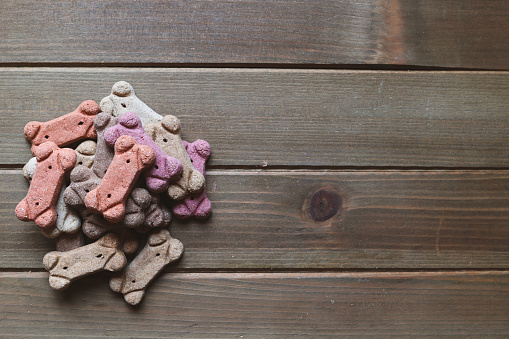 A pile of dog treats on a wooden table