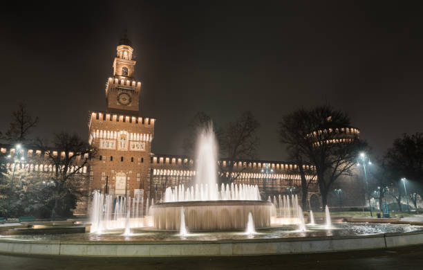 sforza castle, castello sforzesco, is in milan, northern italy. it was built in the 15th century by francesco sforza, duke of milan, on the remnants of a 14th-century fortification. fountain in foreground - milan italy italy castello sforzesco color image imagens e fotografias de stock