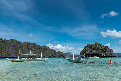 Palawan, Philippines - January 24, 2018: Shimizu Island in El Nido, Palawan. Tour A island with lunch stop. Very popular tour in El Nido. Boats and Rocks in Background.