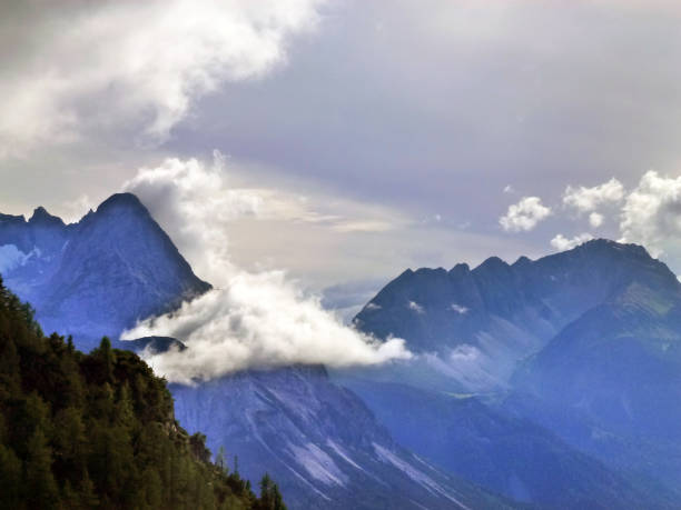 istock High rocks in the mountains between which swirling clouds. A view from afar. Tourist scenic landscape 1501885788