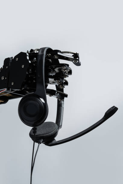 istock Real robot's hand with headset. Concept of Artificial intelligence and Chatbots usage in online business 1501898413