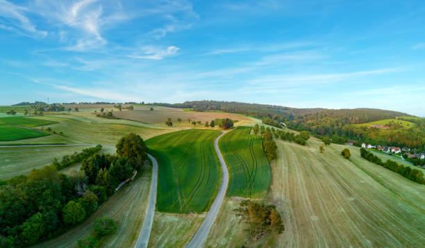 istock Panorama on valley with meadows, fields, forest and farms against a cloudy sky 1501903559