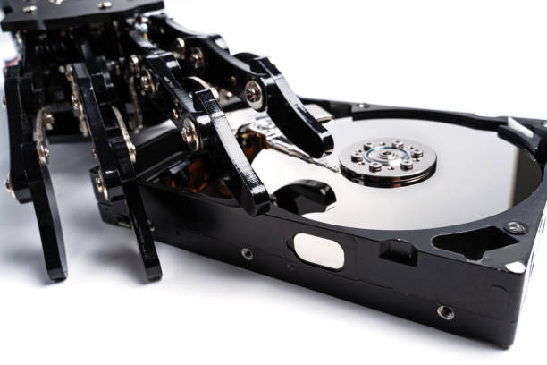 istock Real robotic hand with Hard disk drive. Concepts of AI-powered data protection or machine learning 1501906257