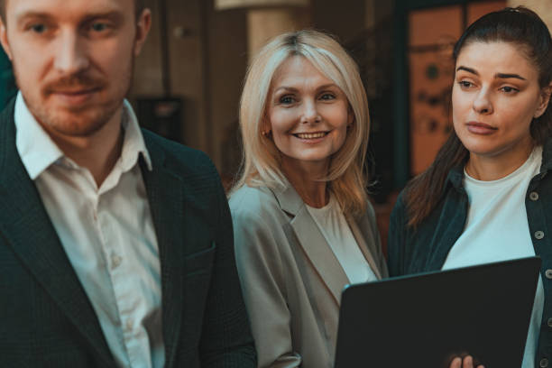 istock Group of smiling coworkers is talking during break time in office. Corporate unity concept 1501906363