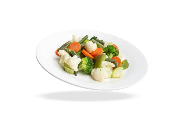 istock steamed vegetables on a white plate on a white background. 1501908564