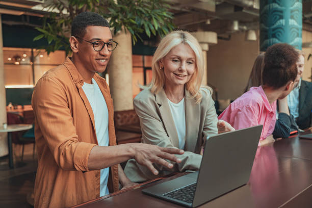 istock Friendly diverse business people laughing working on project together in modern coworking 1501910718