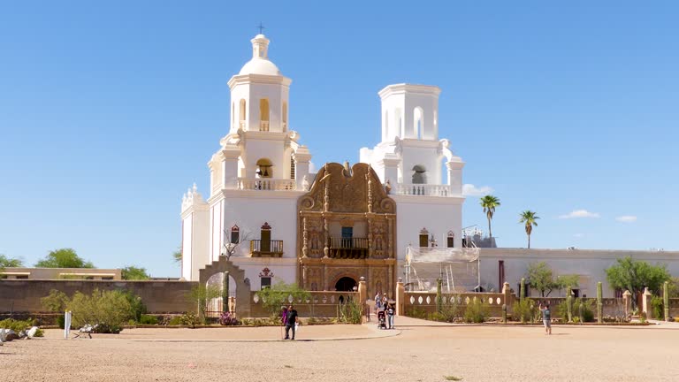 Arizona Mission San Xavier del Bac  A slight side view of the Mission San Xavier del Bac with people