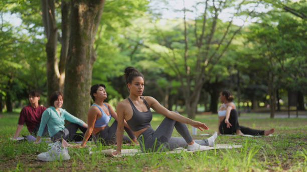 istock Multi-ethnic people practicing in yoga class in nature 1501925398
