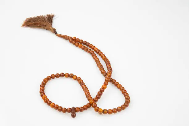 Photo of Muslim rosary beads on white background