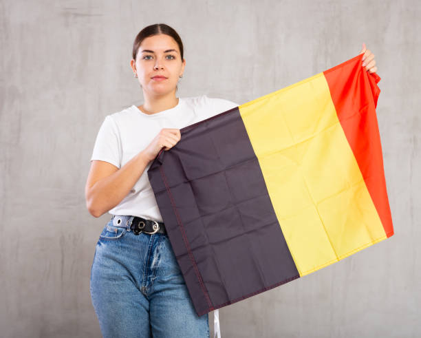 istock Focused young woman holding Belgium flag 1501956314
