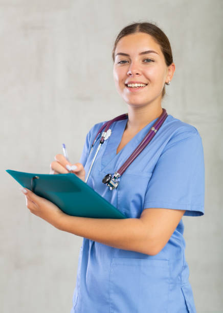 istock Young woman in medical uniform making notes 1501956412