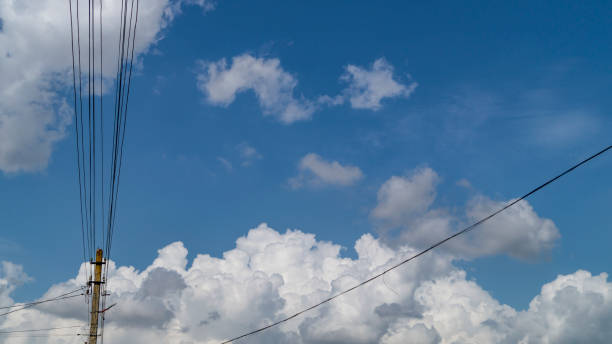 istock Fluffy clouds and electric wires 1501956534