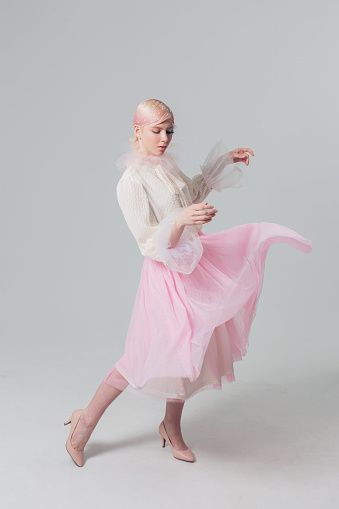 Standing ballerina in a white tutu