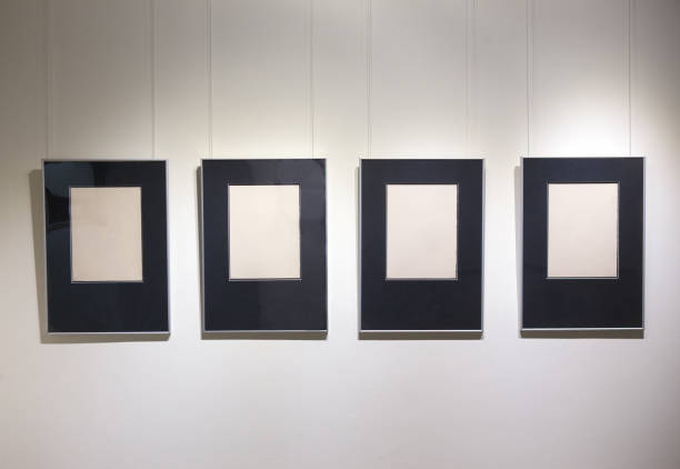 istock Picture frames in a row on a white wall 1501965117