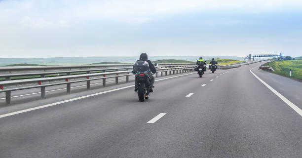 istock Motorcyclists on bikes ride on a country road. 1501967779
