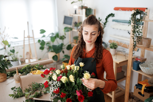 Young woman working in a flower shop