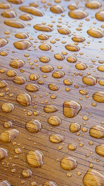 istock Close up on drop of water on a wooden grain surface. 1501973076