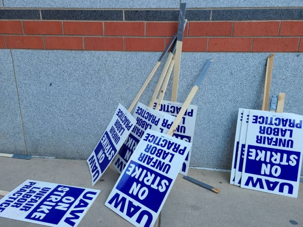 Labor union on strike picketing signs resting on a wall. Labor union on strike picketing signs resting on a wall. striker stock pictures, royalty-free photos & images