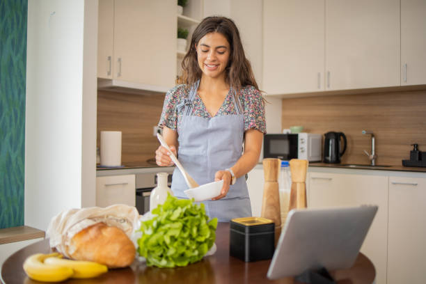istock Young woman is preparing a meal 1501975768