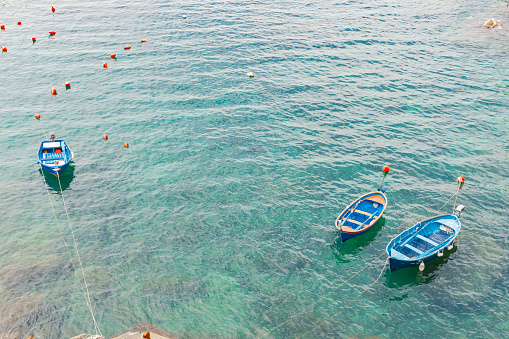 Typical European boats in scenic Riomaggiore bay below on Cinque Terre, Italy.