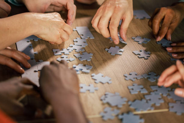 istock Business experts engrossed in puzzle discussion at the table 1501984394