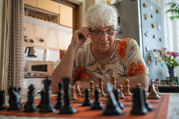 istock Active senior woman playing chess. 1501984589