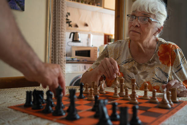istock Active senior woman playing chess. 1501984590