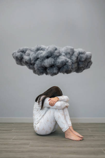 istock Woman with mental disorder and suicidal thoughts crying under a dark storm cloud 1502010936