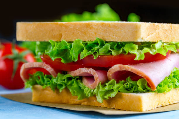 istock Homemade sandwich with ham and fresh vegetables close up 1502018715