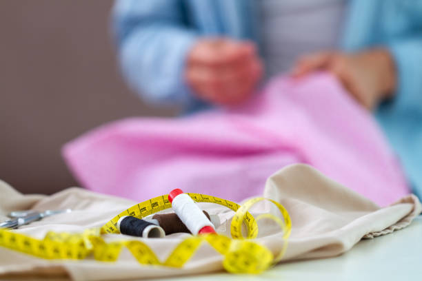 istock Sewing process. Housewife sews at home using various sewing accessories and supplies 1502018725