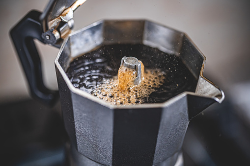 Making black moka coffee using moka coffee maker close-up