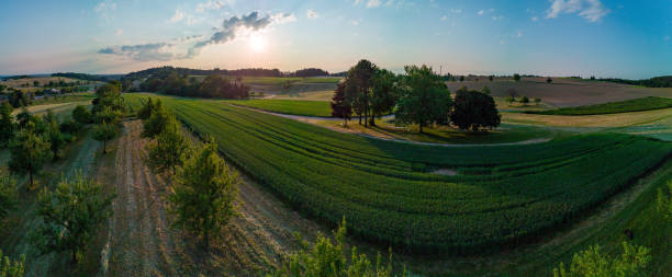 istock Panorama on valley with meadows, fields, forest and farms against a cloudy sky 1502025163
