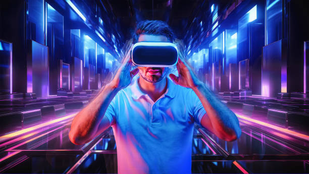 A Caucasian man wearing VR headset and immerses himself in a surreal, futuristic metaverse, where an abstract geometric city unfolds in a kaleidoscope of vibrant neon colors stock photo